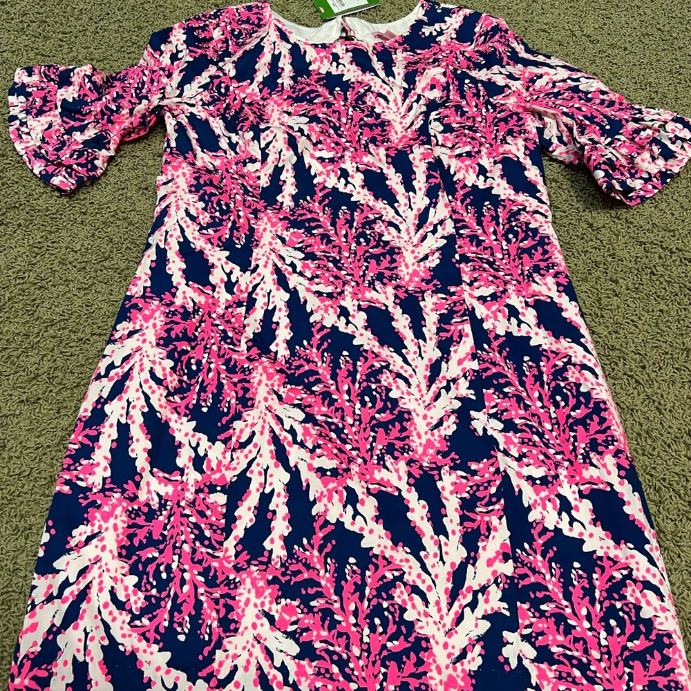 Never worn. Ruffles on sleeves and back keyhole. So cute!!